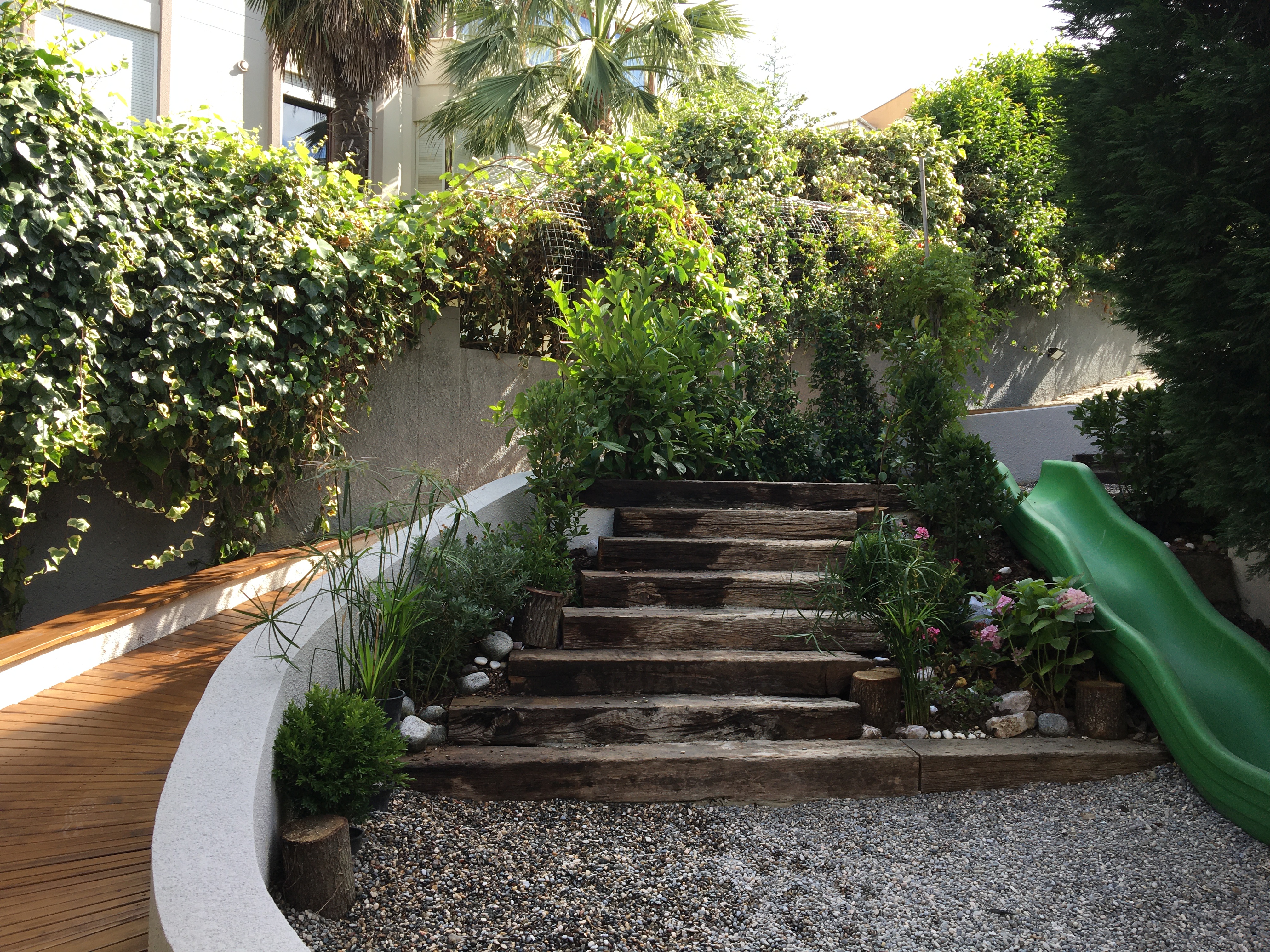 Garden with wooden stairs and lush planting